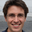 Man in glasses, black shirt smiling — Aipick Zone