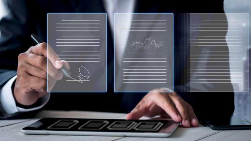 Businessman writing and using tablet — Aipick Zone